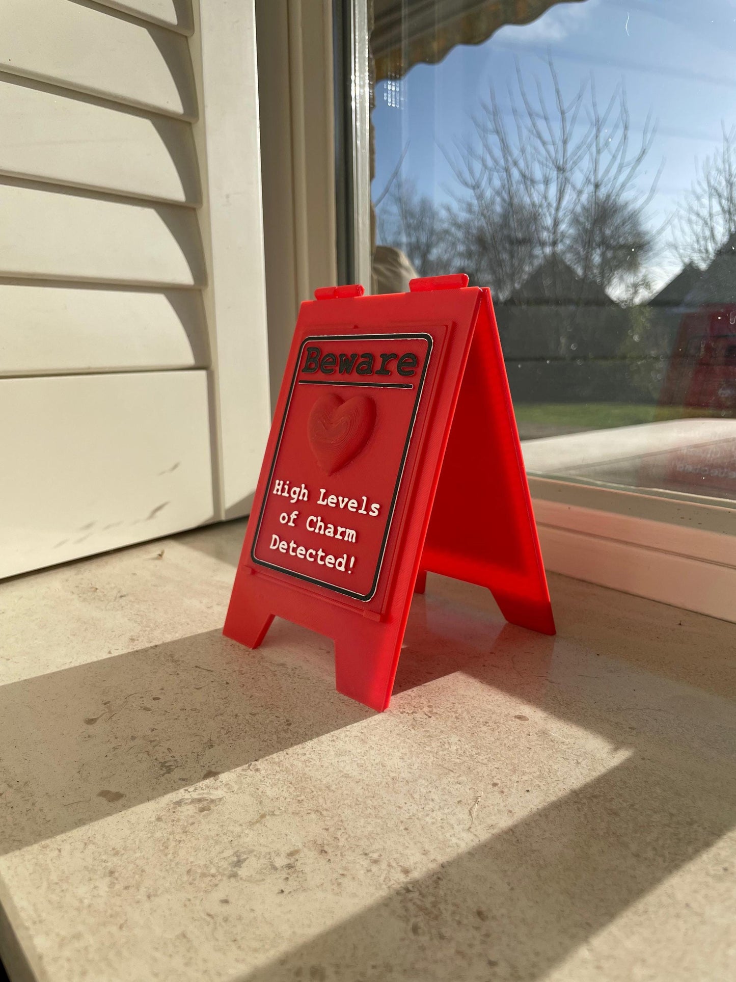 Funny Desk Sign Red A Frame – “Beware High Levels of Charm” Perfect Quirky Gift & Cute Novelty Tabletop Decor!