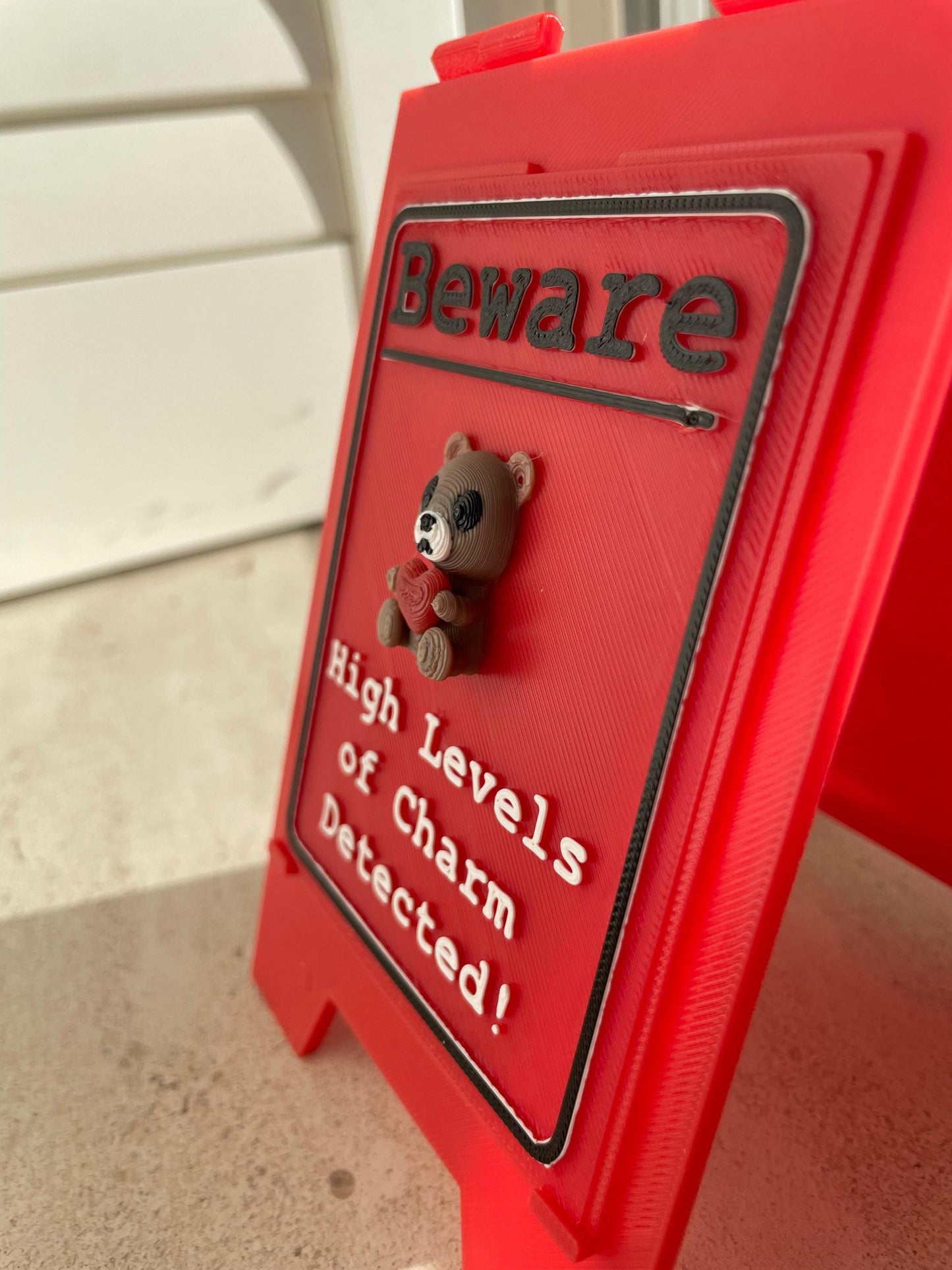 Funny Desk Sign Red A Frame – “Beware High Levels of Charm” Perfect Quirky Gift & Cute Novelty Tabletop Decor!