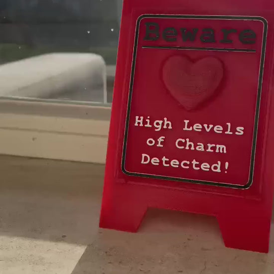 Funny Desk Sign Red A Frame – “Beware High Levels of Charm” Perfect Quirky Gift & Cute Novelty Tabletop Decor!