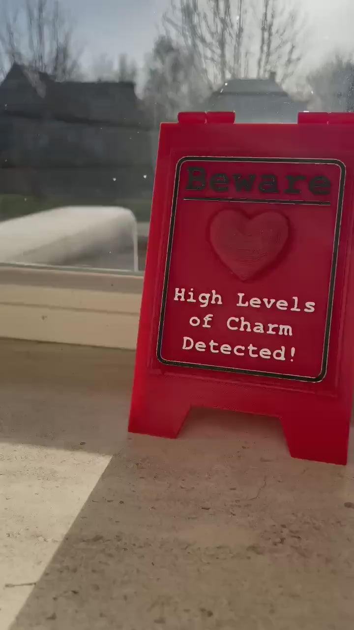 Funny Desk Sign Red A Frame – “Beware High Levels of Charm” Perfect Quirky Gift & Cute Novelty Tabletop Decor!